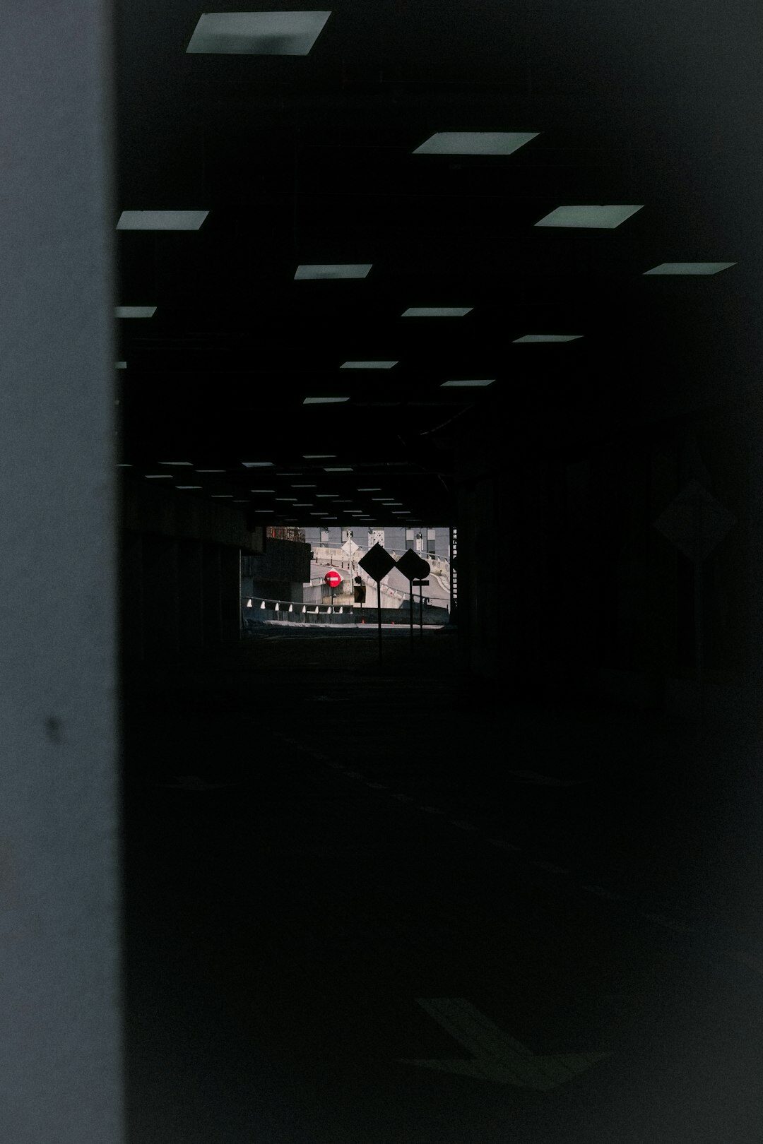 Wide view of a television control room with a wall of preview screens