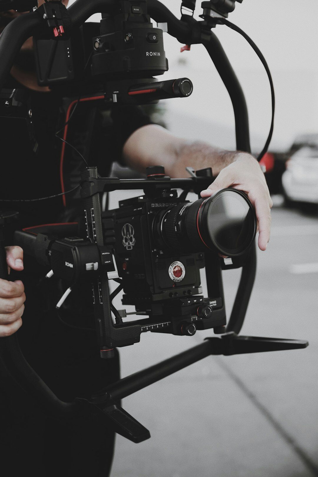 Camera operator filming with a shoulder-mounted broadcast camera